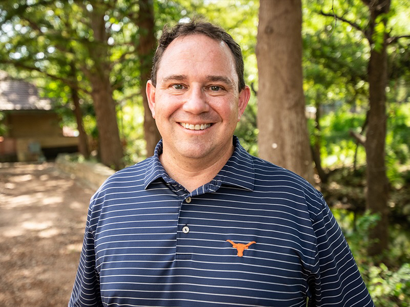 Michael Webber in front of a wooded area